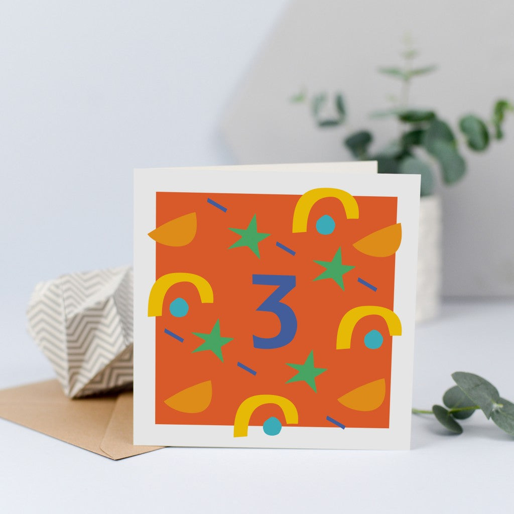 A unisex third birthday card with bright colours and shapes