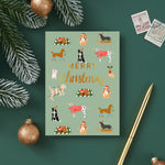 Christmas card with dog illustrations on a green background, surrounded by festive decorations.
