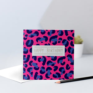 A hot pink and blue leopard print birthday card finished with "Happy birthday" in gold foil.