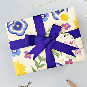 botanical wrapping paper with an indigo ribbon bow