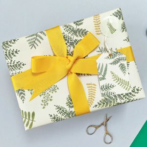 fern wrapping paper with matching fern gift tag and yellow ribbon bow
