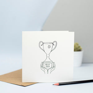 An illustration of some hands holding a trophy with a plaque that says "Best Mum".  A lovely card for your mum on her birthday or for mothers' day.