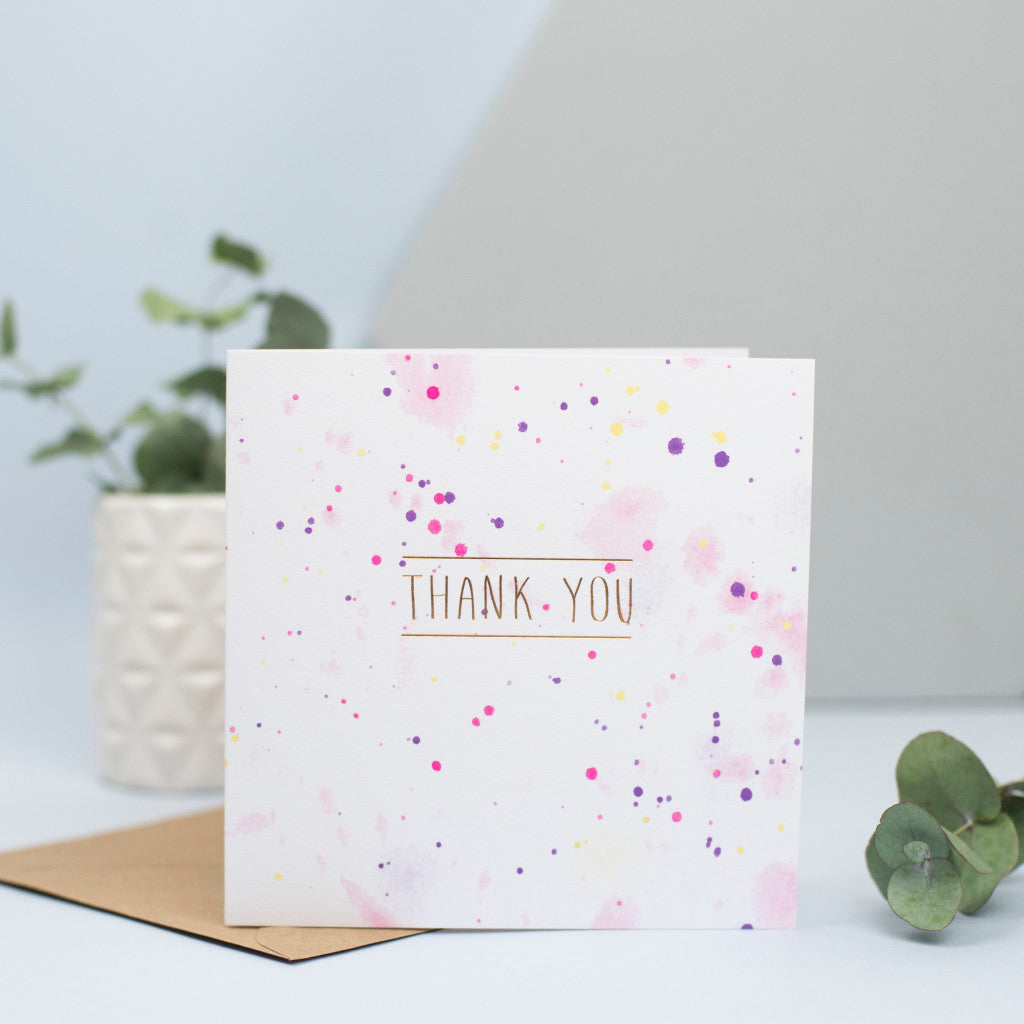 A watercolour and gold foil thank you card.