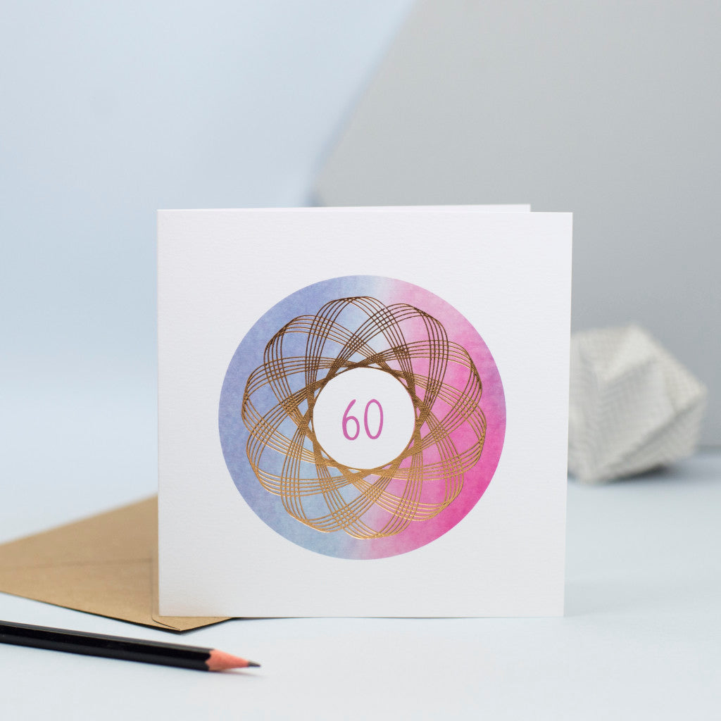 A luxury 60th birthday card with a gold foiled spirograph over a watercolour background.