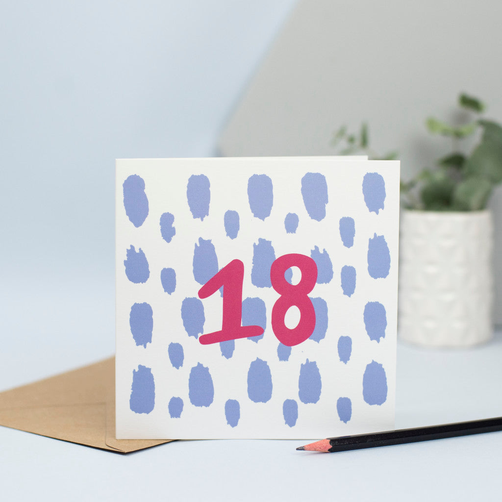 A simple design for an 18th birthday with large pale blue splurges in the background and the number 18 in maroon in the foreground.