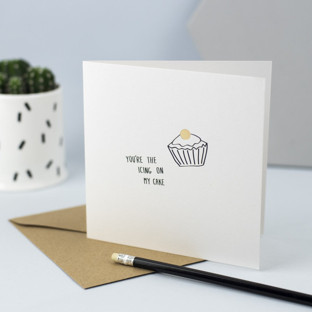 Hand drawn illustration of a cupcake with gold foil and the words "You're the icing on my cake"