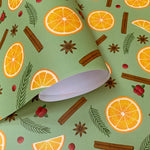 Oranges and cinnamon wrapping paper roll