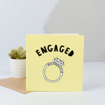 An engagement card with an illustration of a large diamond ring.