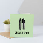 a clever you card with an illustration of some pens and pencils