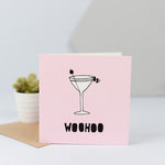 A celebratory card with a drawing of a martini glass and the word "Woohoo".