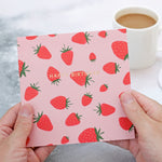 hands holding gold foiled strawberry birthday card