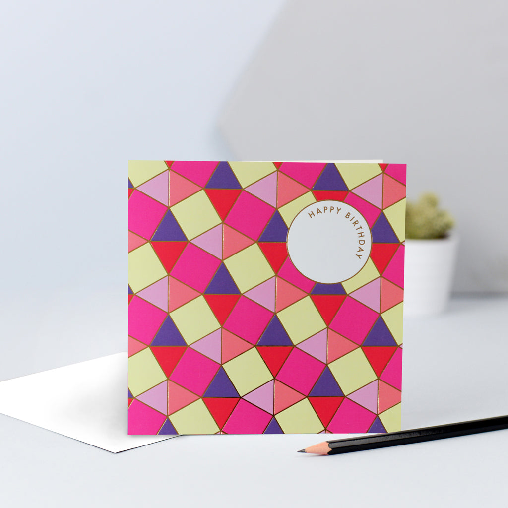 A pink, red purple and yellow tessellating birthday card with gold foil