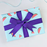 watermelon wrapping paper with an indigo ribbon bow